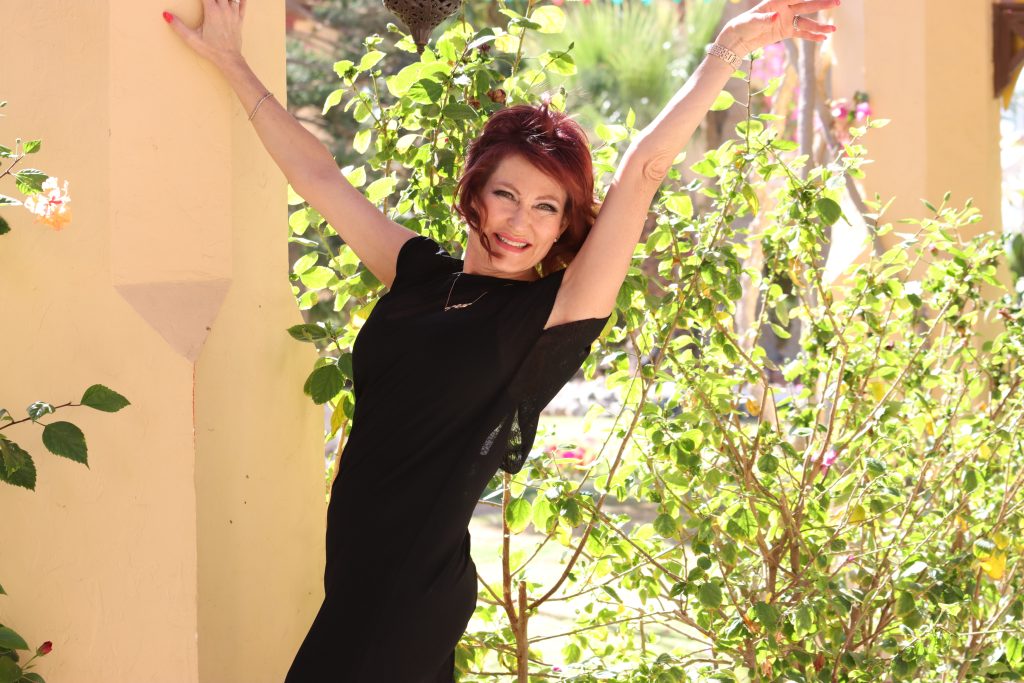 Mo Hagan posing with her arms out.